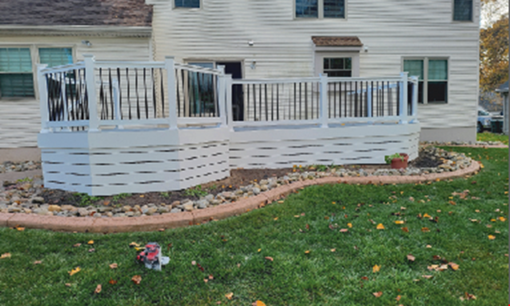 Product image for LESCAS ENTERPRISES INC. NowJust$2,99510' x 10' Trex Composite deck with hidden fasteners
and white vinyl railing with aluminum balusters 